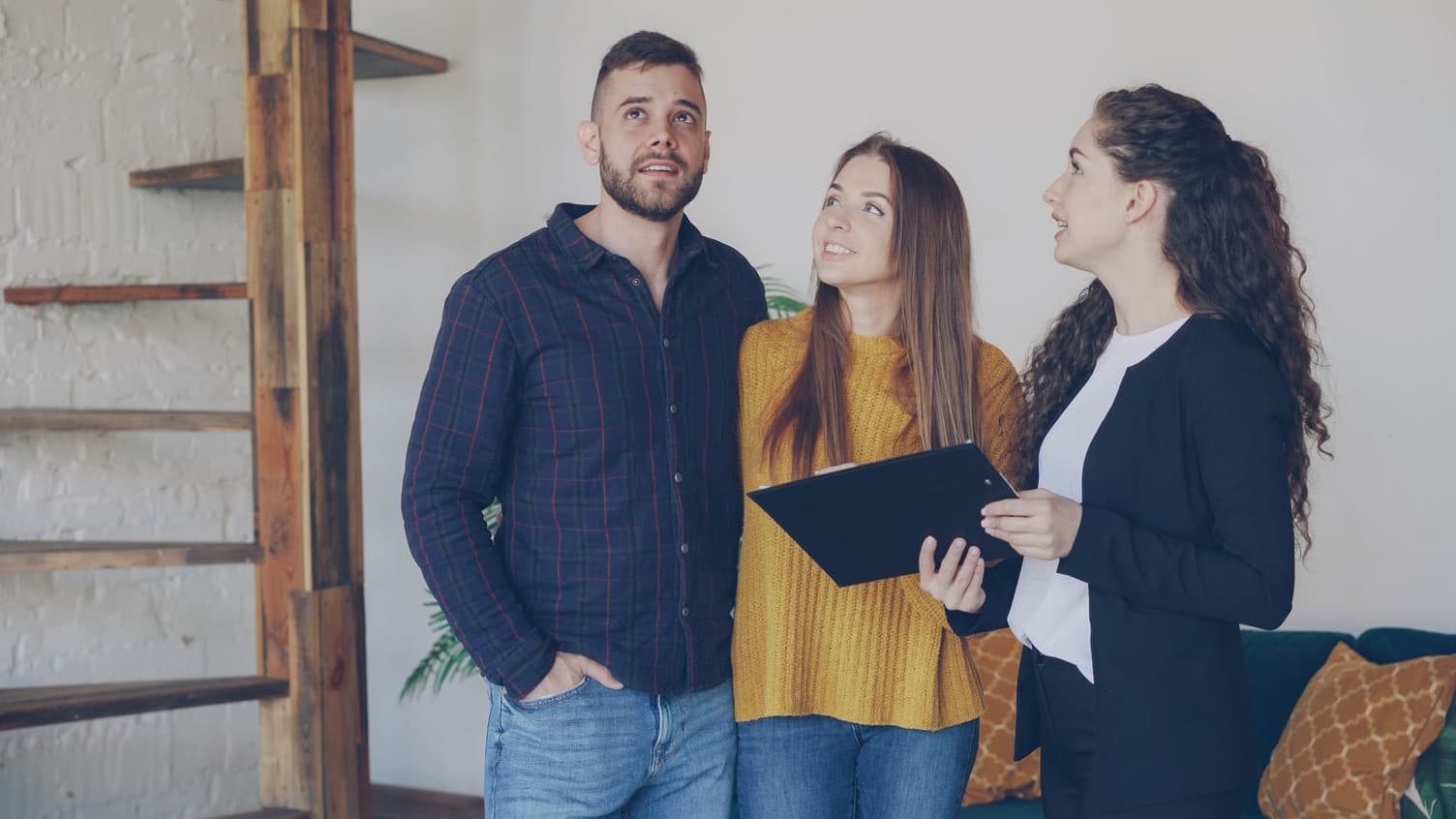 Agent handing house keys to a happy couple